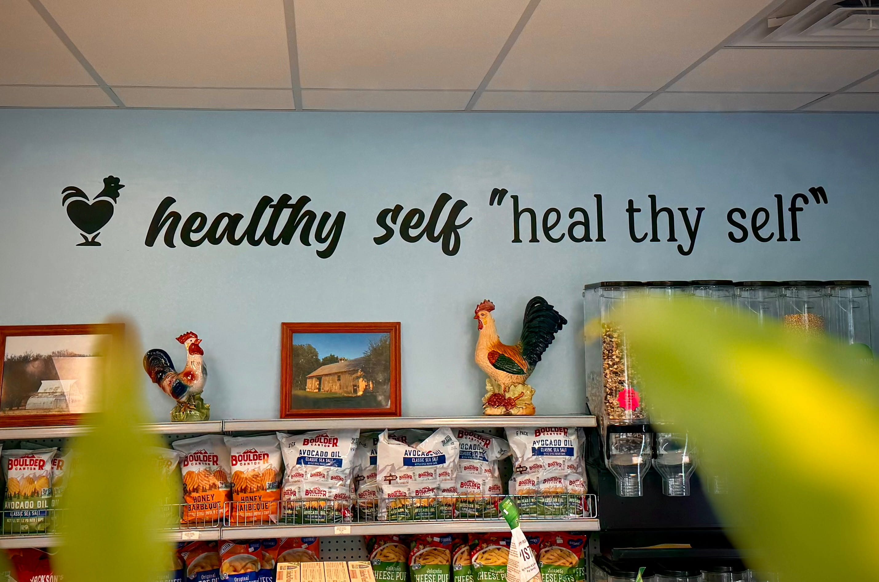 "Heal Thy Self" inspirational wellness quote displayed as wall art inside the store