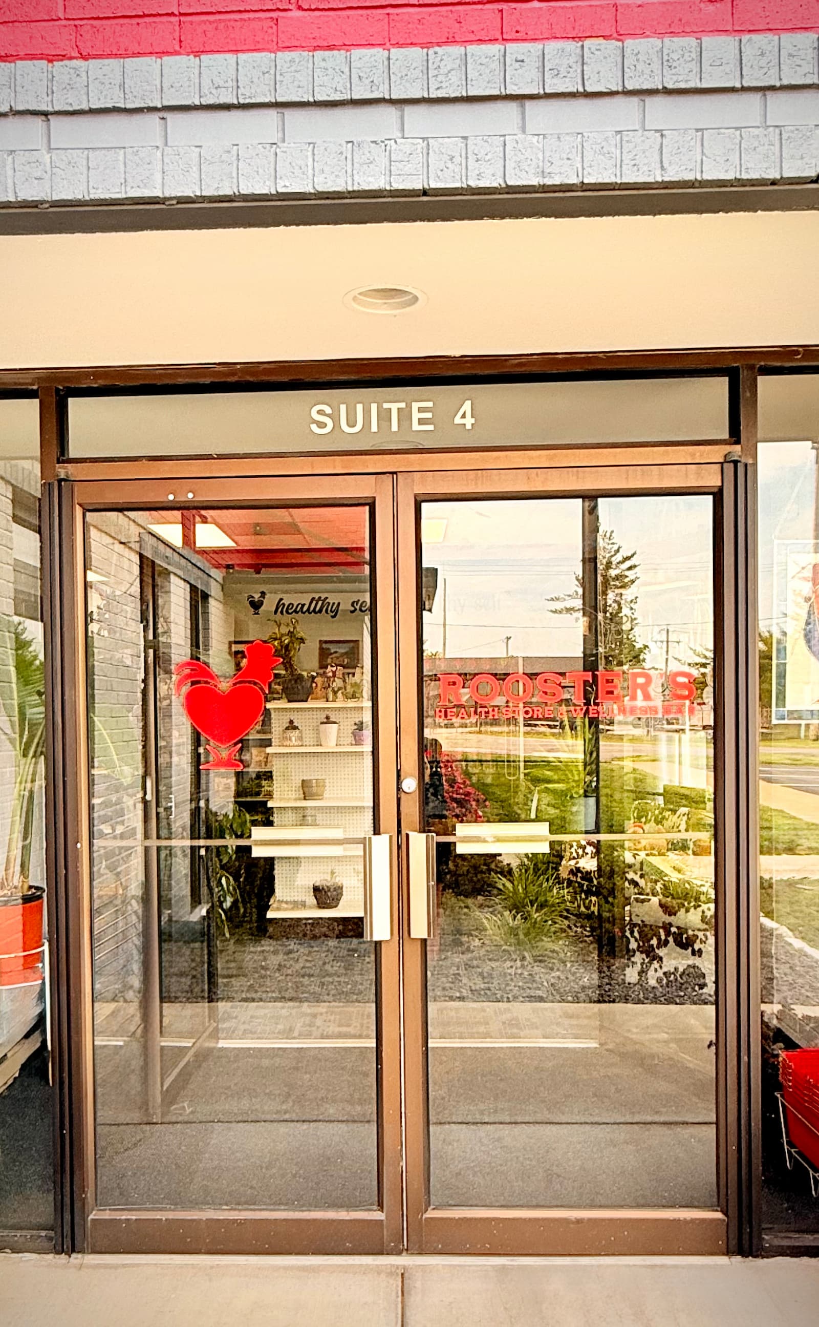 Glass entrance doors to Rooster's Health Store in Columbia, Illinois